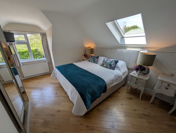 Double bedroom with skylight and garden view