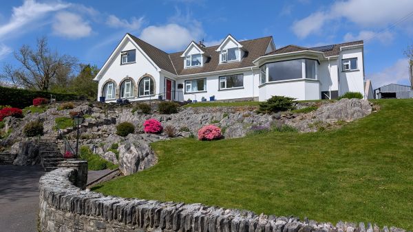 Rockcrest House full exterior with landscaped gardens
